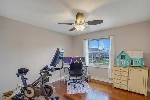 exercise room featuring baseboards, ceiling fan, and hardwood / wood-style floors