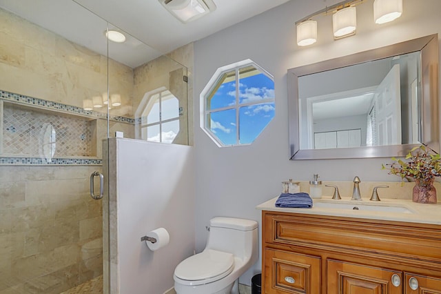 bathroom featuring a stall shower, vanity, and toilet