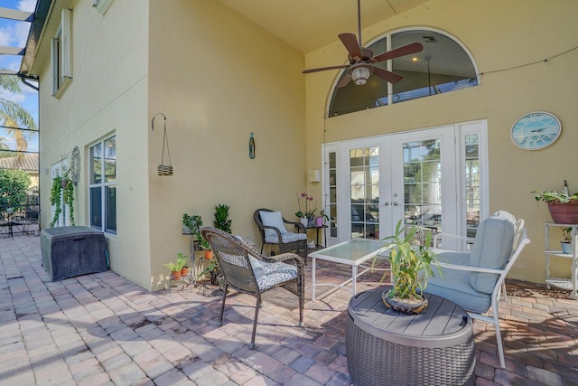 view of patio with a ceiling fan, french doors, and glass enclosure