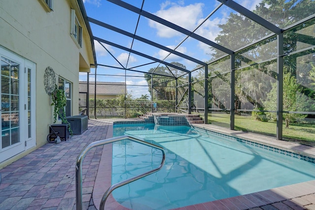 view of pool featuring a patio, a lanai, and a pool with connected hot tub