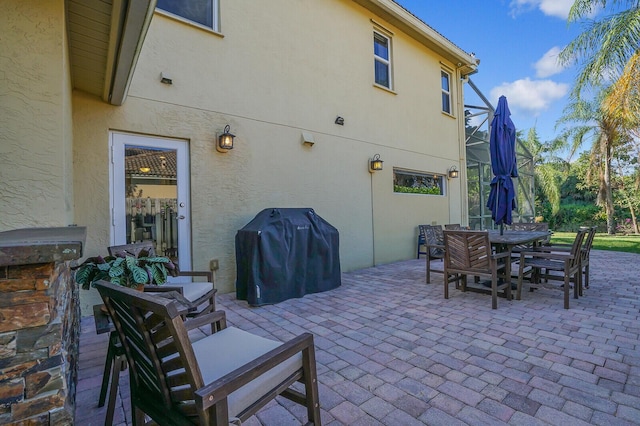 view of patio with outdoor dining area and grilling area