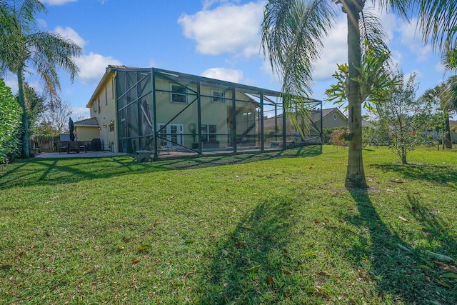 view of yard with a patio and glass enclosure