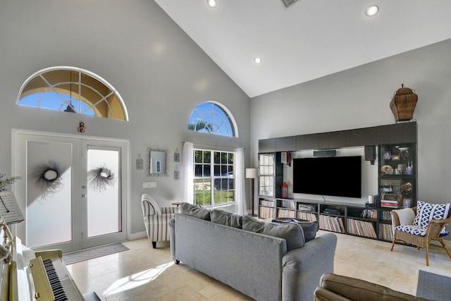 living area with high vaulted ceiling, recessed lighting, french doors, and visible vents