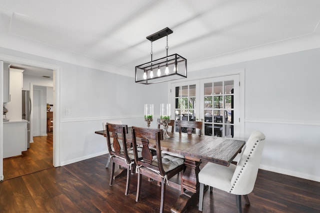 dining area featuring dark wood-style floors and baseboards