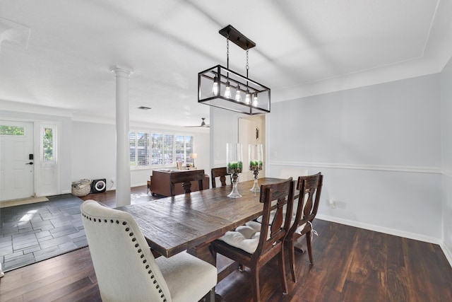 dining area with ornate columns, baseboards, and dark wood-style flooring