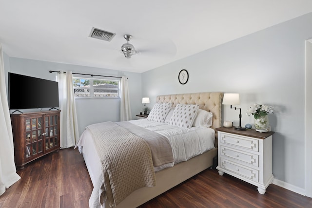 bedroom with visible vents, dark wood finished floors, and baseboards