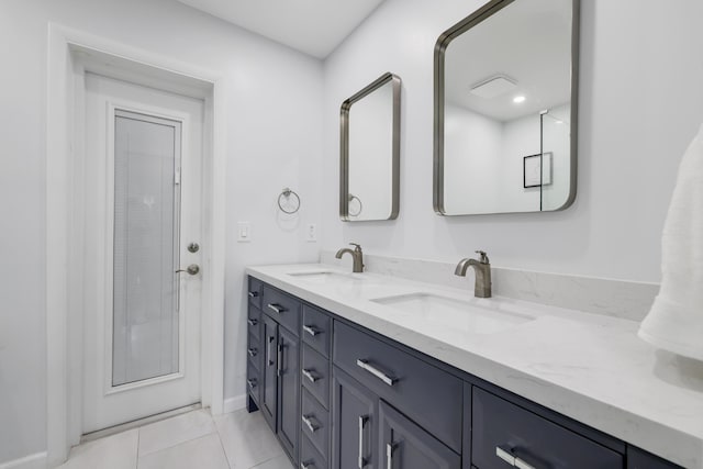 bathroom featuring double vanity, a sink, and tile patterned floors