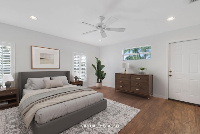 bedroom with baseboards, dark wood-type flooring, and recessed lighting