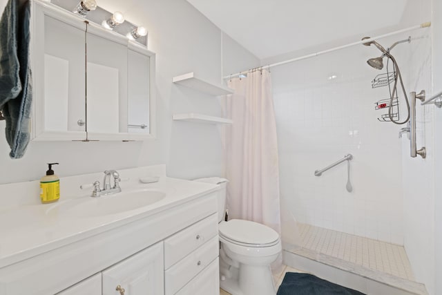 bathroom featuring a shower stall, toilet, and vanity