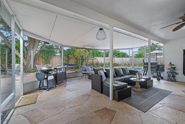 sunroom featuring ceiling fan