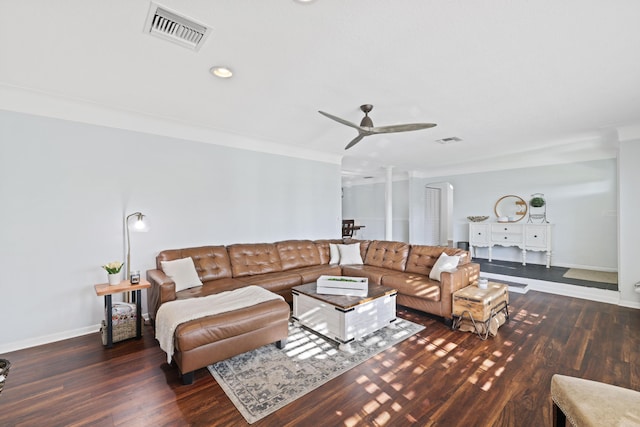 living area featuring a ceiling fan, arched walkways, visible vents, and dark wood finished floors