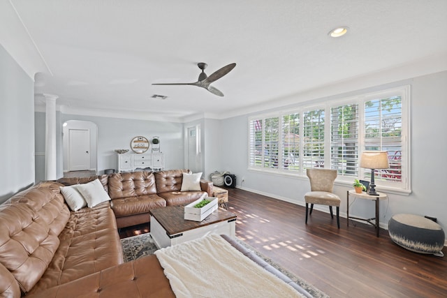 living room featuring dark wood-style flooring, ornate columns, visible vents, a ceiling fan, and baseboards