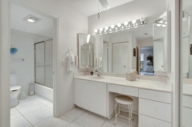 full bath featuring enclosed tub / shower combo, tile patterned flooring, toilet, vanity, and a closet