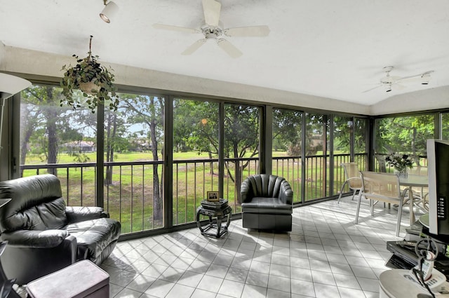 sunroom / solarium with a ceiling fan and vaulted ceiling