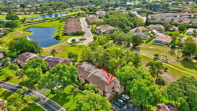 birds eye view of property with a water view and a residential view