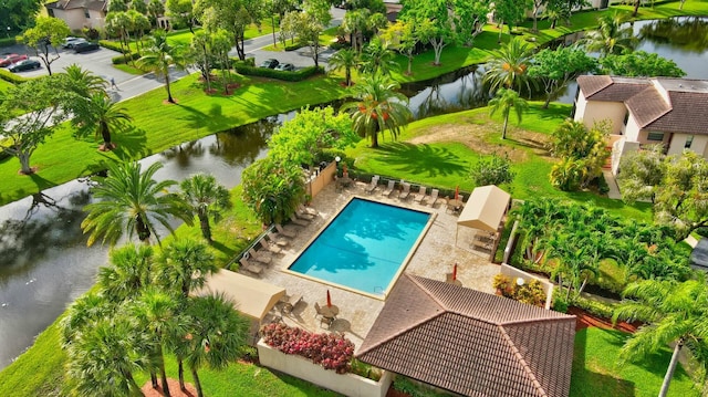 view of swimming pool with a water view, a fenced backyard, a fenced in pool, and a patio