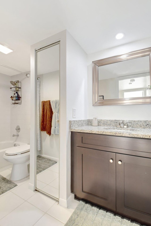 bathroom with toilet, vanity, washtub / shower combination, and tile patterned floors