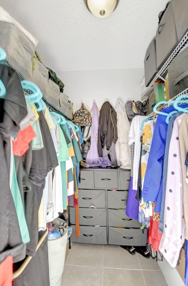walk in closet featuring tile patterned flooring