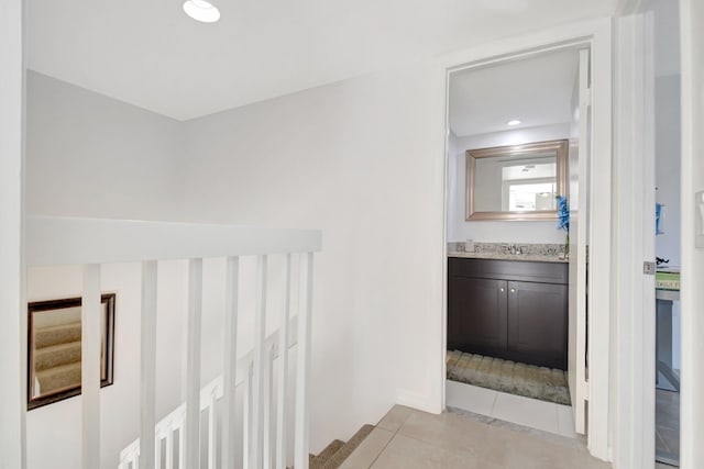hall featuring light tile patterned floors and recessed lighting