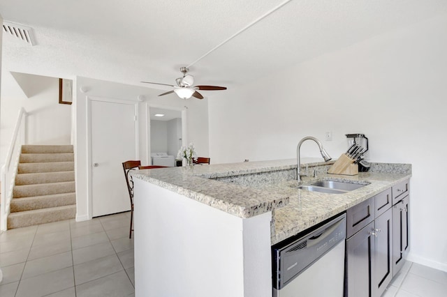 kitchen featuring dishwasher, light tile patterned floors, ceiling fan, visible vents, and a sink