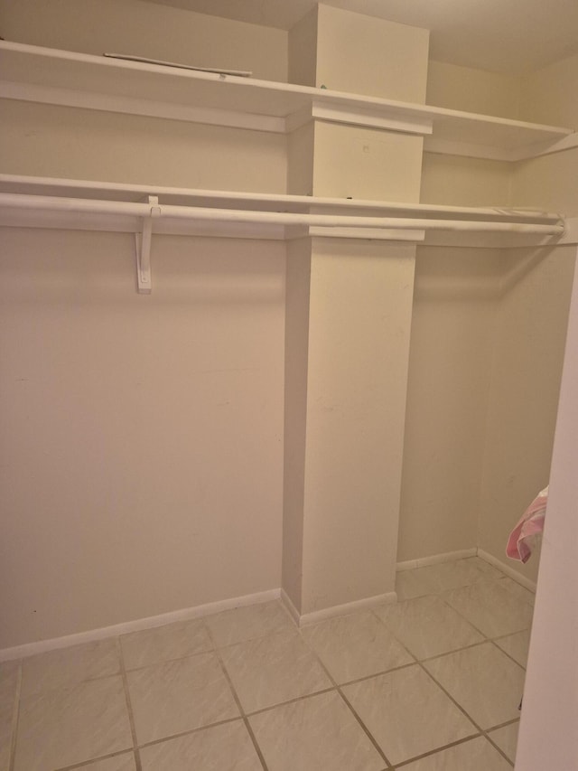 walk in closet featuring tile patterned flooring