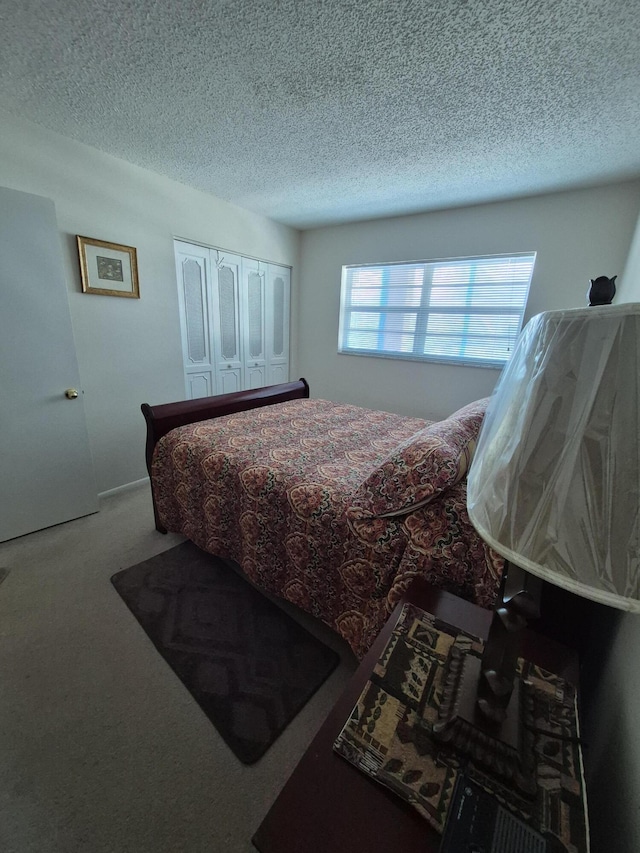 bedroom featuring carpet floors and a textured ceiling