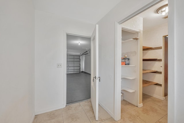 interior space with baseboards and tile patterned floors