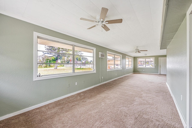 empty room featuring baseboards, a ceiling fan, a textured wall, an AC wall unit, and carpet flooring