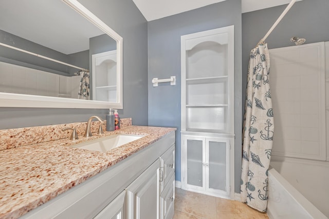 full bath featuring shower / tub combo, tile patterned flooring, and vanity