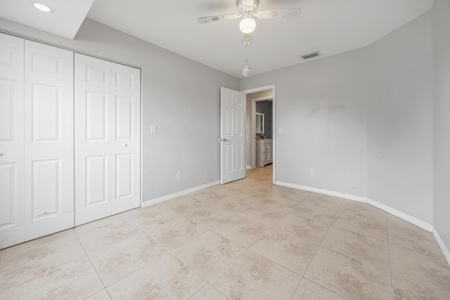 unfurnished bedroom with a closet, visible vents, baseboards, and light tile patterned floors