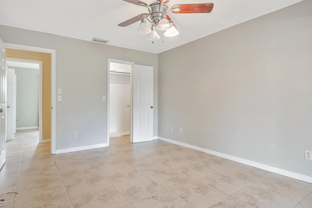 unfurnished bedroom with a ceiling fan, visible vents, and baseboards