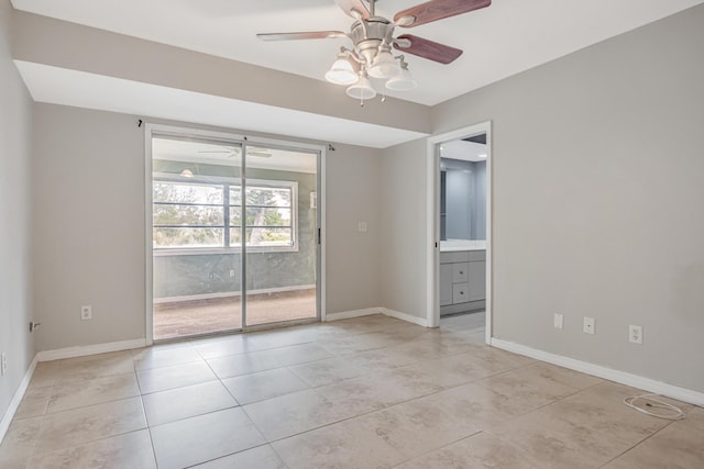 unfurnished room with light tile patterned floors, ceiling fan, and baseboards