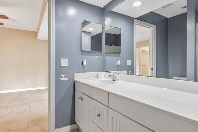 bathroom featuring tile patterned flooring, visible vents, vanity, and baseboards