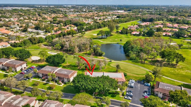 aerial view featuring view of golf course, a water view, and a residential view