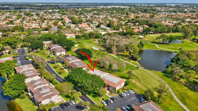 birds eye view of property with golf course view, a water view, and a residential view