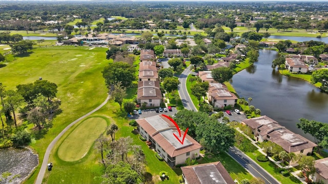 aerial view with a residential view, a water view, and golf course view