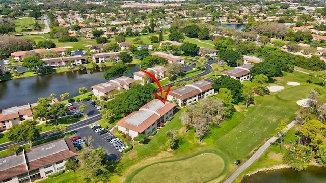 bird's eye view with view of golf course, a water view, and a residential view