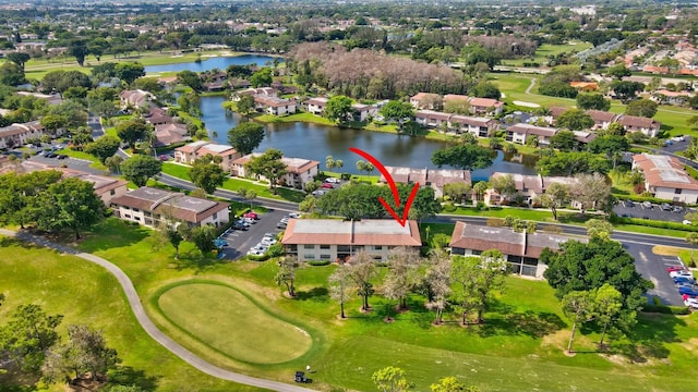 aerial view with a residential view, a water view, and golf course view