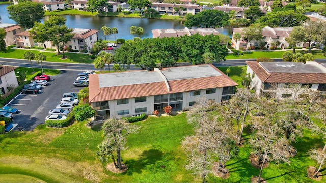 birds eye view of property featuring a water view and a residential view