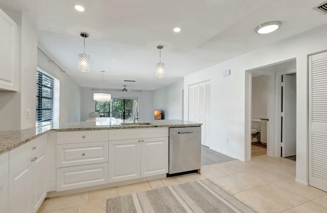 kitchen with white cabinets, dishwasher, light stone counters, pendant lighting, and a sink