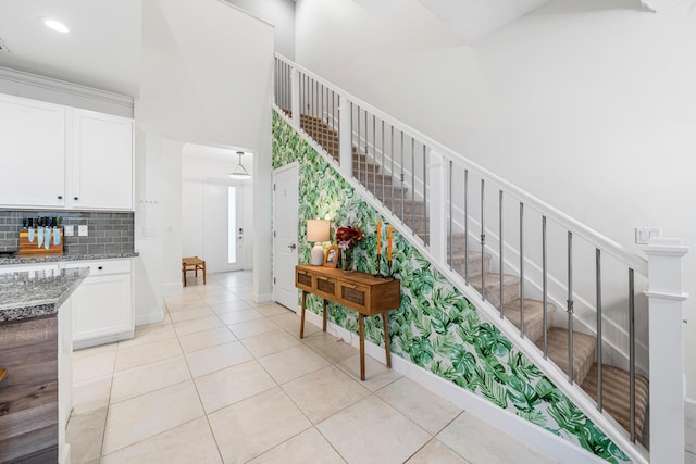 stairs with tile patterned flooring and baseboards