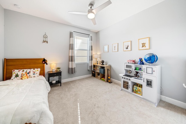 bedroom featuring light colored carpet, ceiling fan, and baseboards