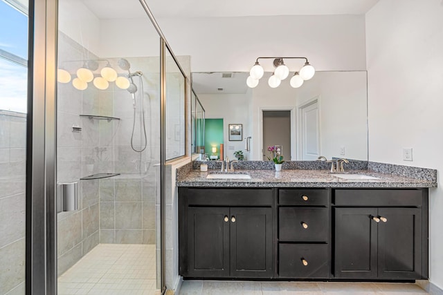 full bath with double vanity, a stall shower, and a sink