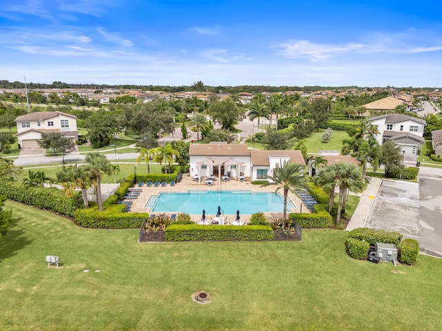 pool featuring a residential view, a patio, and a lawn