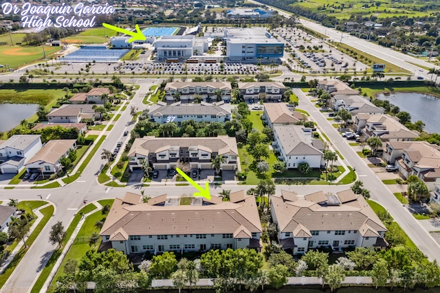 drone / aerial view featuring a water view and a residential view