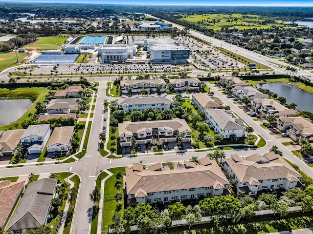 birds eye view of property featuring a water view and a residential view