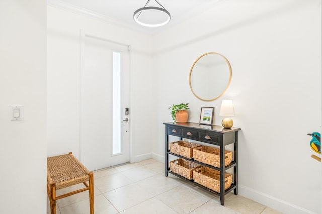 entryway featuring light tile patterned flooring, crown molding, and baseboards