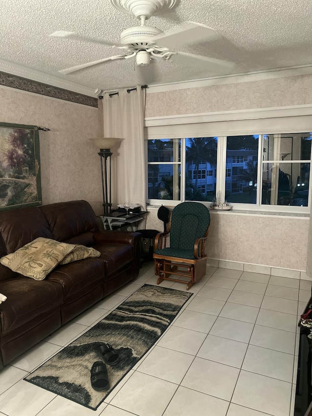 tiled living area featuring ceiling fan and a textured ceiling