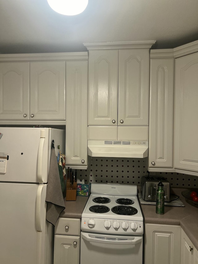 kitchen featuring white appliances, under cabinet range hood, and white cabinetry