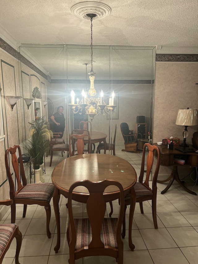 tiled dining space with a chandelier, a textured ceiling, and crown molding